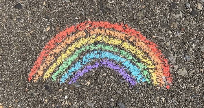 Chalk drawing of rainbow on concrete