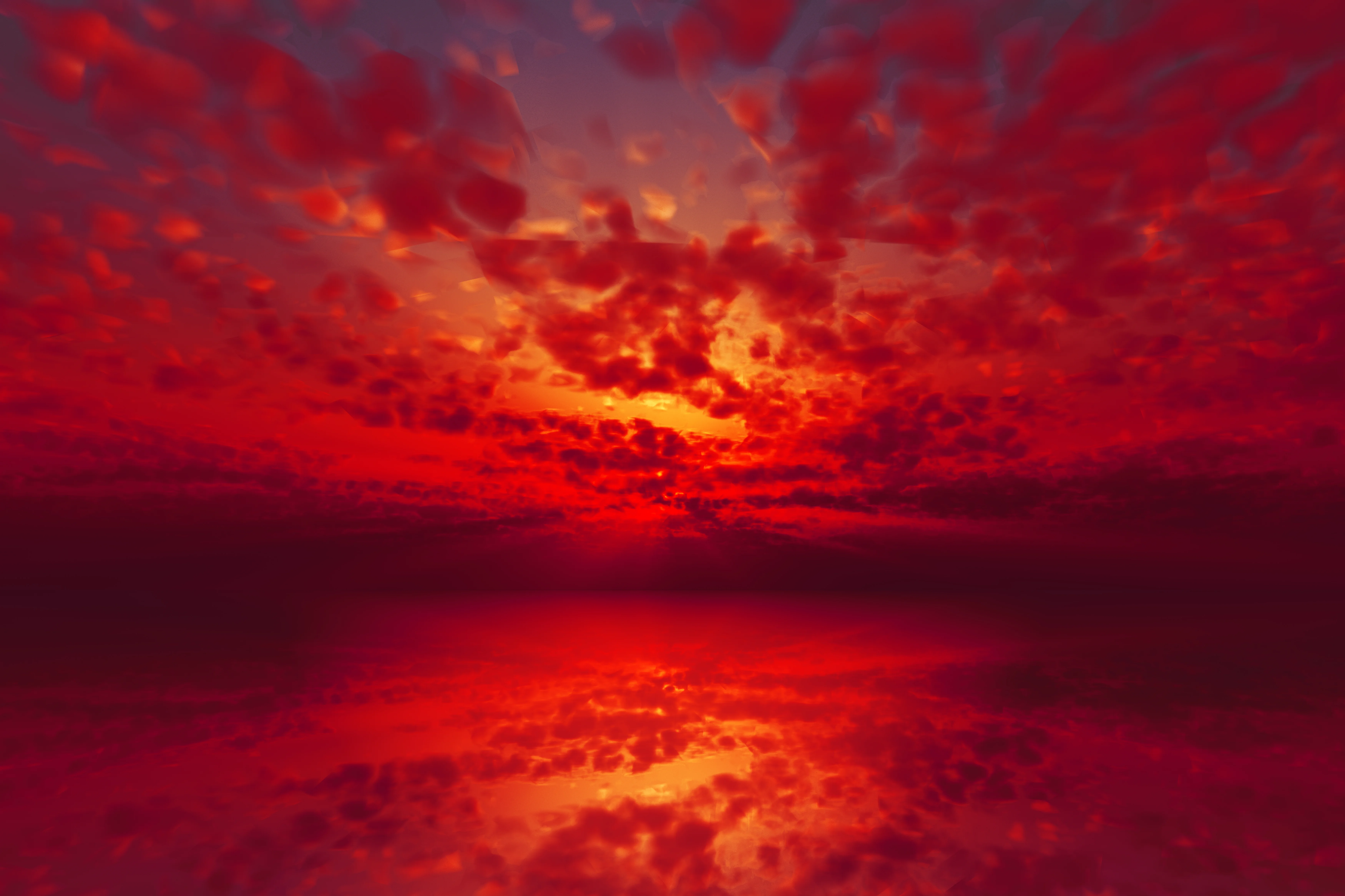 Fiery red and orange sunset with red clouds reflected in the water